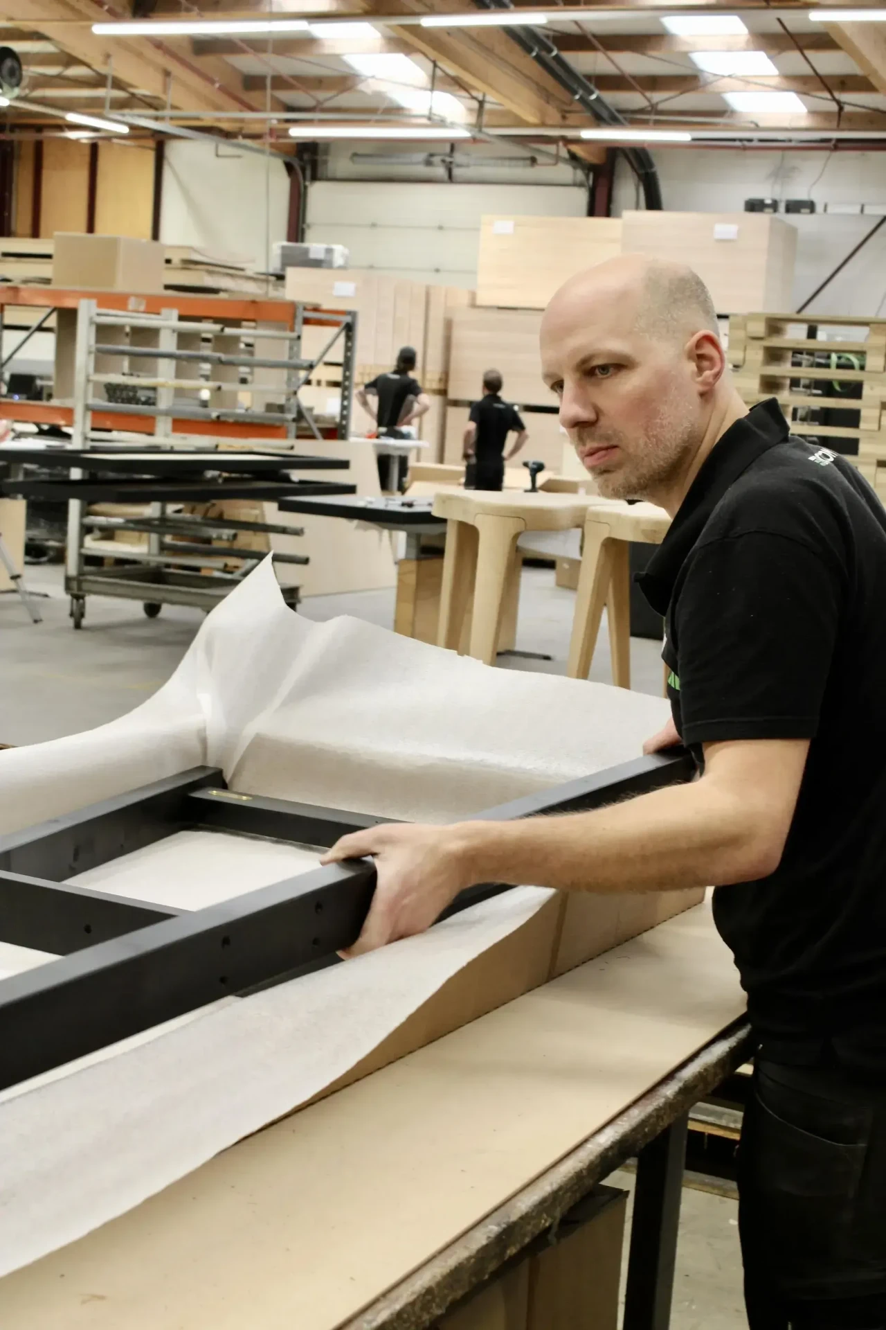 Shuffly team member working on a shuffleboard frame in the workshop